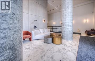 Kitchener condo for rent - A living room with a white couch and a marble floor.