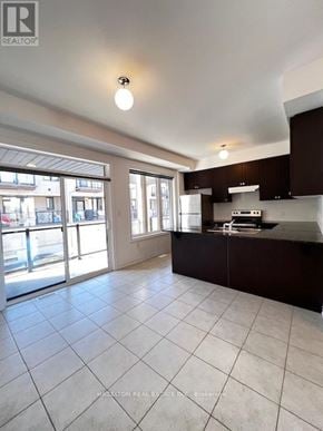 Whitby (Port Whitby) townhouse for rent - A kitchen with dark brown cabinets and a white fridge.
