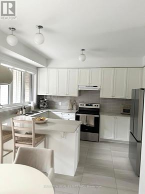 Whitby (Port Whitby) townhouse for rent - A kitchen with white cabinets and appliances.