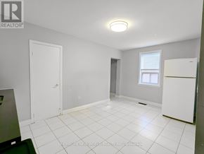 Toronto (Caledonia-Fairbank) apartment for rent - A white tiled room with a refrigerator and a window.
