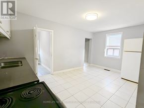 Toronto (Caledonia-Fairbank) apartment for rent - A kitchen with a stove top oven and a refrigerator.