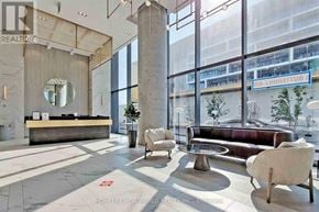 Vaughan (Vaughan Corporate Centre) condo for rent - A lobby with a reception desk and a large window.