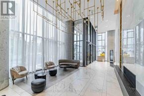 Vaughan (Vaughan Corporate Centre) condo for rent - A spacious lobby with a marble floor and gold accents.