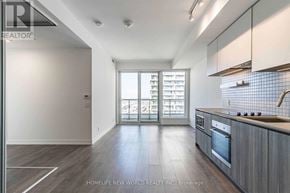 Vaughan (Vaughan Corporate Centre) condo for rent - A kitchen with wooden cabinets and a stainless steel stove top.