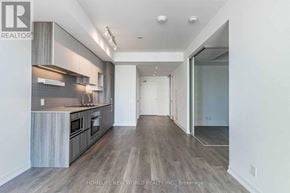Vaughan (Vaughan Corporate Centre) condo for rent - A spacious kitchen with wooden floors and modern appliances.