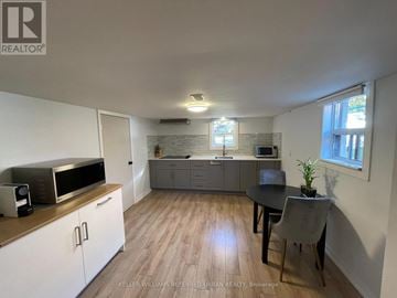 Toronto (Stonegate-Queensway) apartment for rent - A kitchen with a microwave, oven, and sink.