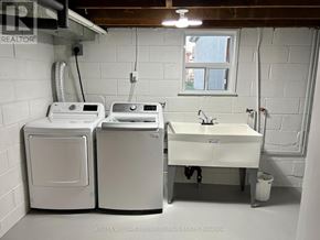 Toronto (Stonegate-Queensway) apartment for rent - A white laundry room with a washer and dryer and a sink.