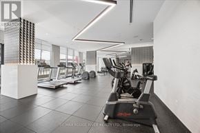 Oshawa (Windfields) condo for rent - A gym with a variety of equipment including treadmills, stationary bikes, and weight machines.