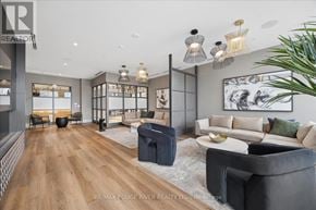 Oshawa (Windfields) condo for rent - A modern living room with a grey sofa and a wooden floor.