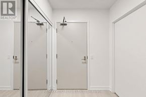 Toronto (Humber Heights) condo for rent - Three white doors in a hallway with a brokerage sign on the wall.