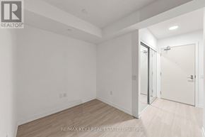 Toronto (Humber Heights) condo for rent - A white room with a sliding glass door and a wooden floor.