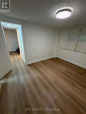 Toronto (Runnymede-Bloor West Village) apartment for rent - A room with wooden flooring and a ceiling light.