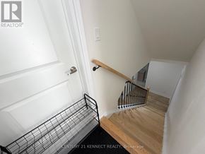 Oakville (Jm Joshua Meadows) apartment for rent - A staircase with a metal railing and wooden steps.