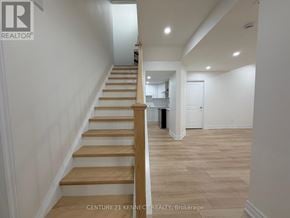Oakville (Jm Joshua Meadows) apartment for rent - A staircase with wooden steps and a white wall.