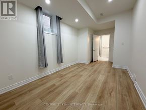 Oakville (Jm Joshua Meadows) apartment for rent - A room with wooden flooring and a window with curtains.
