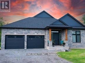 Fort Erie (Crescent Park) apartment for rent - A house with a stone facade and two garage doors is for sale in Brokerage, North Carolina.
