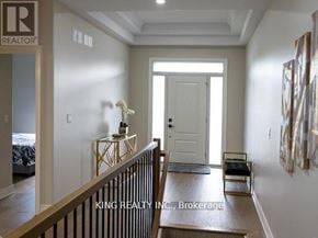 Fort Erie (Crescent Park) apartment for rent - A hallway with a white door and a table with flowers on it.