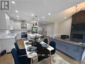 Fort Erie (Crescent Park) apartment for rent - A dining room with a table set for two and a kitchen area in the background.