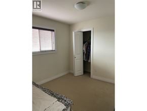 Burnaby apartment for rent - A bedroom with a bed and a closet.
