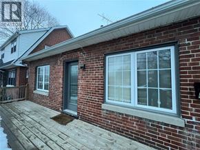 Chatham apartment for rent - A red brick house with a grey door and a grey window.
