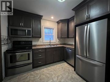Chatham apartment for rent - A kitchen with black cabinets and stainless steel appliances.