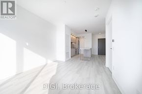 Toronto (Waterfront Communities) condo for rent - A room with white walls and a wooden floor is shown.