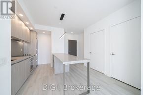 Toronto (Waterfront Communities) condo for rent - A modern kitchen with a dining table and chairs.