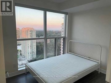 Toronto (Bendale) condo for rent - A bedroom with a large bed and a view of the city.