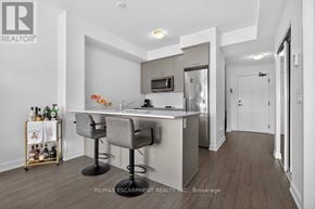 Hamilton (Lakeshore) condo for rent - A modern kitchen with a bar area and a wine rack.