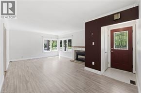 Hamilton apartment for rent - A spacious room with a fireplace and a door leading to another room.