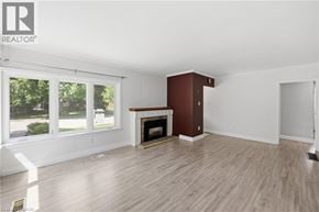Hamilton apartment for rent - A room with a fireplace and a large window.