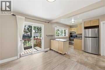 Hamilton apartment for rent - A kitchen with wooden cabinets and a stainless steel refrigerator.