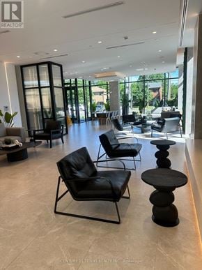 Toronto (Bayview Village) condo for rent - A waiting area with black chairs and tables.