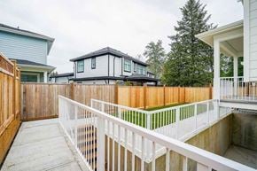 Surrey apartment for rent - A white fence separates a backyard from a house.