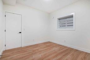 Surrey apartment for rent - A room with a white door and a window with blinds.