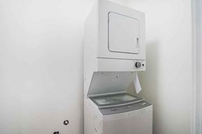 Surrey apartment for rent - A white oven with a door and a control panel is installed in a white wall.