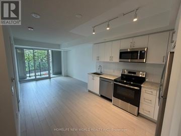 Toronto (Humber Heights) condo for rent - A kitchen with white cabinets and a black stove top oven.