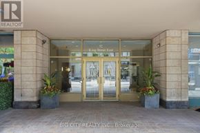 Toronto (Church-Yonge Corridor) condo for rent - The entrance to a building with a glass door and a sign that reads "King Street East".