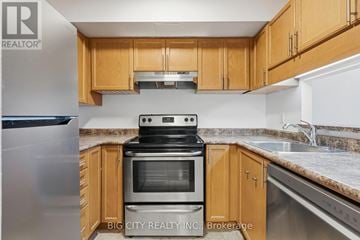 Toronto (Church-Yonge Corridor) condo for rent - A kitchen with wooden cabinets and a stainless steel refrigerator.