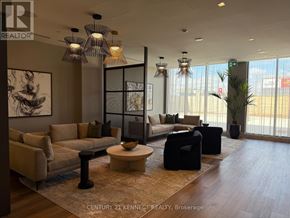 Oshawa (Windfields) condo for rent - A well-lit waiting area with a mix of seating options and decorative lighting fixtures.