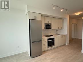 Oshawa (Windfields) condo for rent - A kitchen with a refrigerator, microwave, and oven.