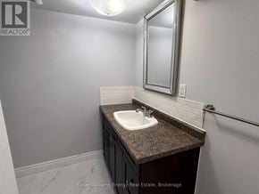 Oshawa (Donevan) apartment for rent - A bathroom with a sink and mirror.