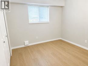 Burnaby apartment for rent - A room with a window and wooden flooring.