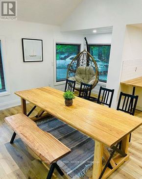 Innisfil apartment for rent - A wooden dining table with four chairs and a bench.