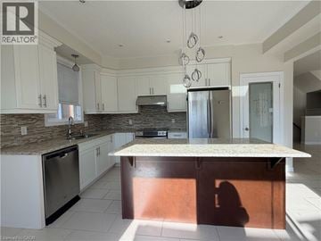 Waterloo apartment for rent - A kitchen with a granite counter top and a refrigerator.