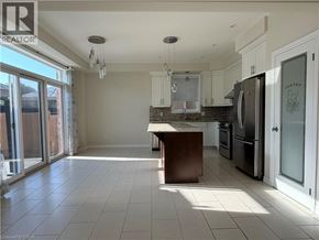 Waterloo apartment for rent - A kitchen with a refrigerator, sink, and a table.