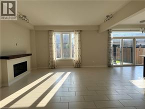 Waterloo apartment for rent - A spacious living room with a fireplace and sliding glass doors.