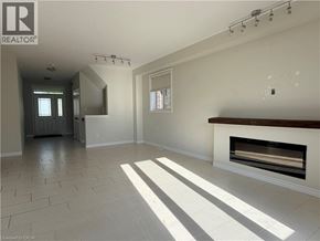Waterloo apartment for rent - A large, empty room with a fireplace and a tiled floor.