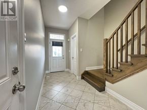 Barrie (Painswick South) apartment for rent - A hallway with a staircase and a door on the left.