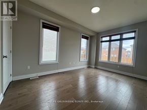 Barrie (Painswick South) apartment for rent - A room with wooden flooring and two windows.